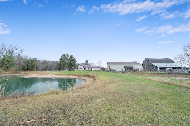 view of yard featuring a water view and an outdoor structure