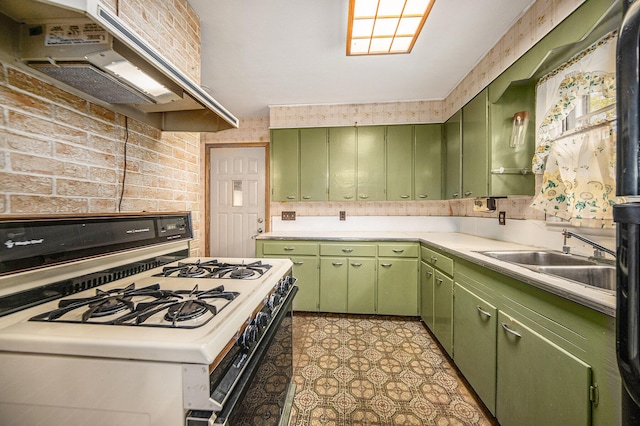 kitchen with white gas range, sink, green cabinets, and ventilation hood