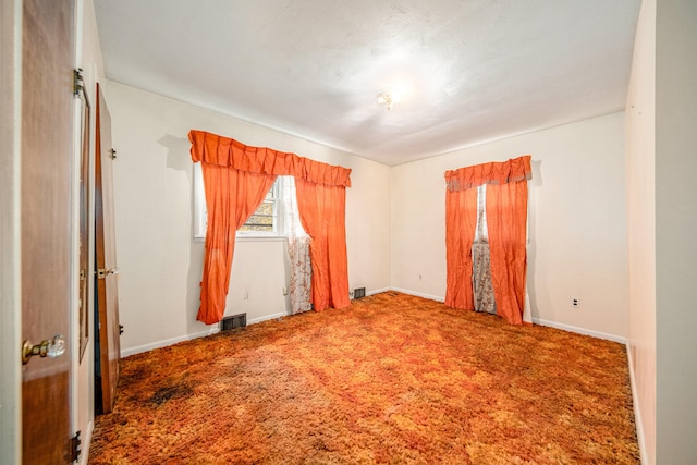 empty room featuring carpet flooring