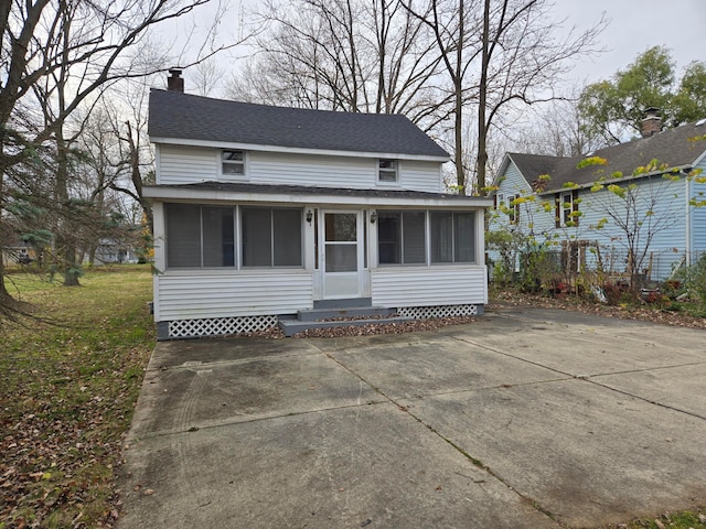 view of front of house with a sunroom