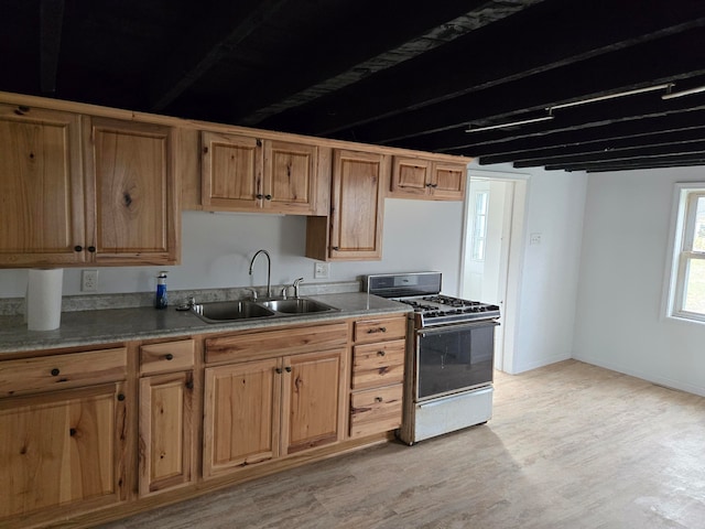 kitchen featuring sink, light wood-type flooring, and white gas range oven