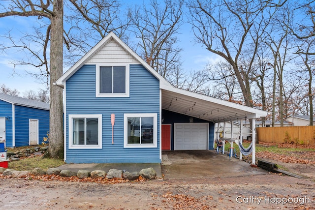 view of front of house with a garage and a carport