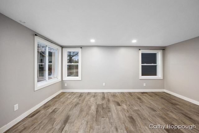 unfurnished room with wood-type flooring