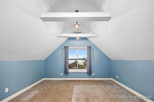 bonus room featuring a textured ceiling, carpet floors, and vaulted ceiling