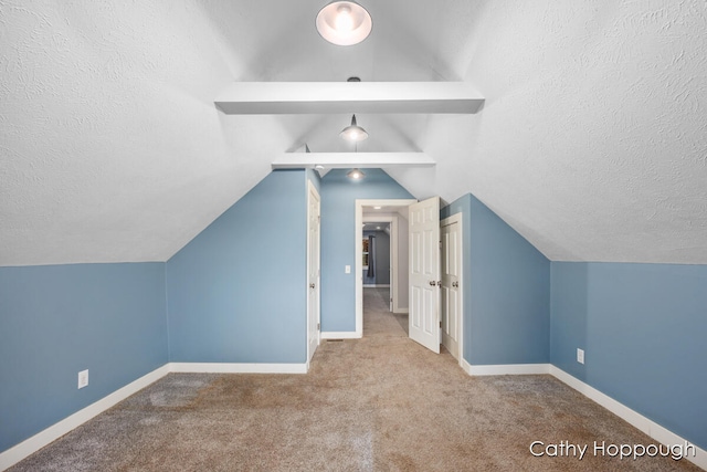 additional living space featuring vaulted ceiling, light colored carpet, and a textured ceiling