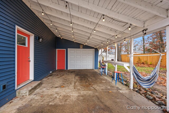 view of patio / terrace with a garage and a carport