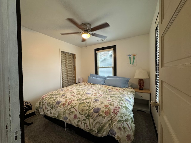 bedroom featuring dark colored carpet and ceiling fan