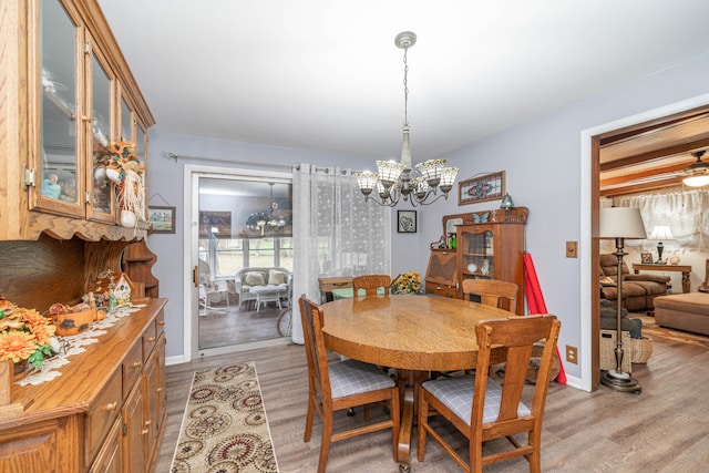 dining room featuring an inviting chandelier and light hardwood / wood-style flooring