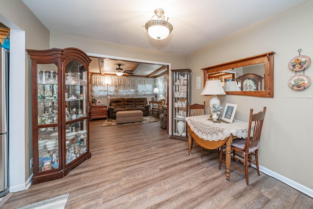 dining space with wood-type flooring and ceiling fan