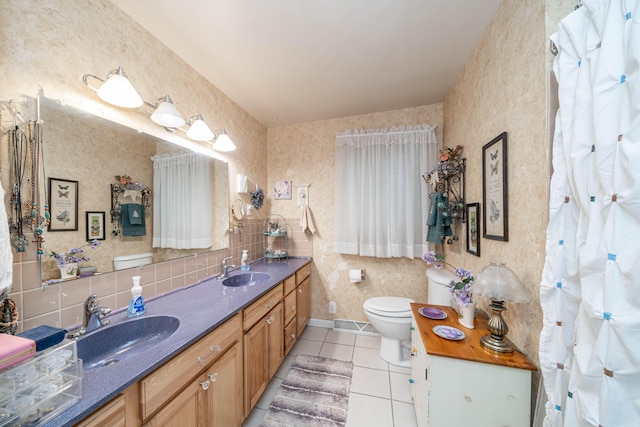 bathroom featuring toilet, vanity, tile patterned floors, and backsplash