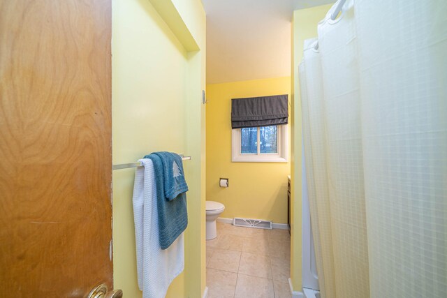 bathroom featuring tile patterned flooring and toilet