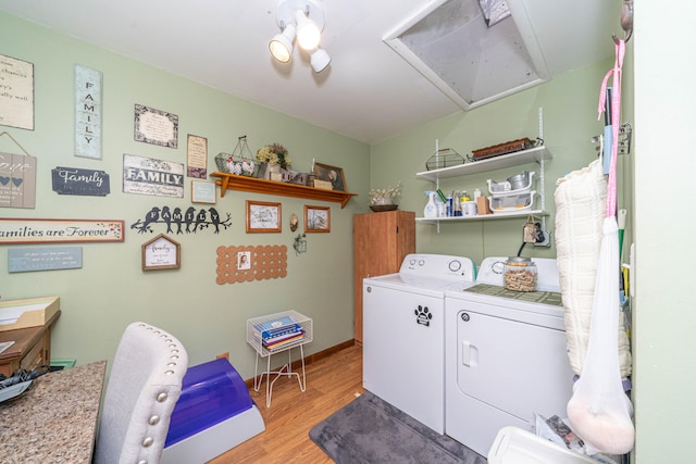 laundry area with independent washer and dryer and light wood-type flooring