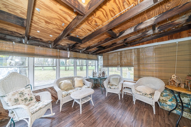 sunroom / solarium featuring vaulted ceiling with beams