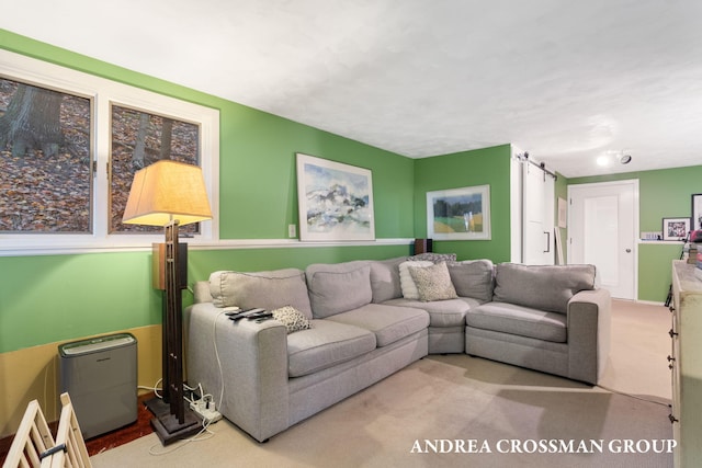 carpeted living room with a barn door