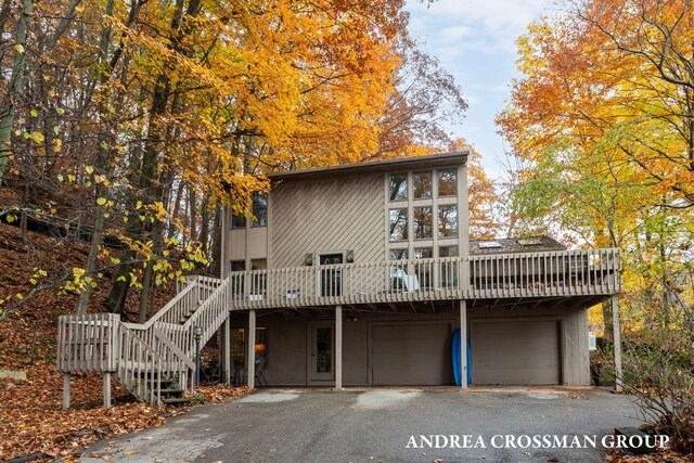 view of front facade with a garage and a deck