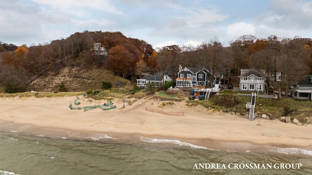 exterior space featuring a water view and a beach view