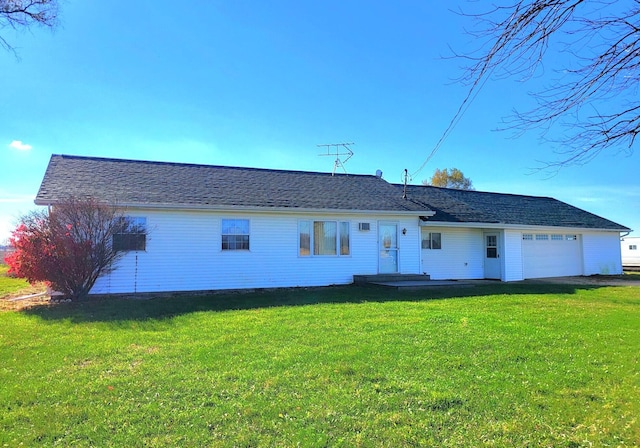 view of front of house with a front yard and a garage