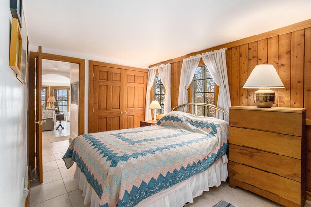 tiled bedroom with a closet