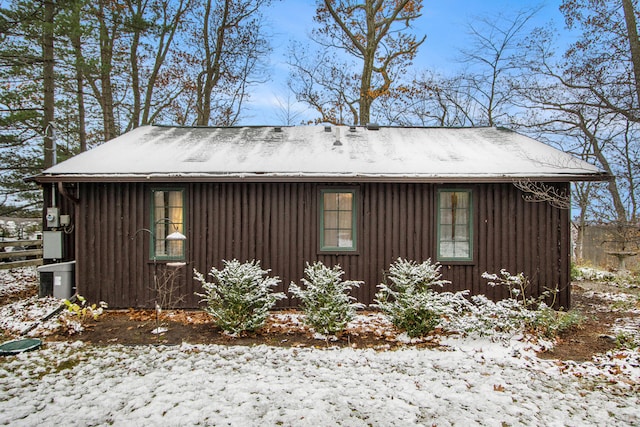 view of snowy exterior featuring an outdoor structure