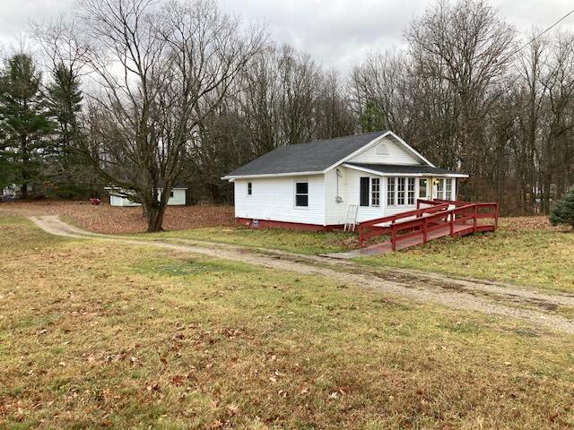 view of side of home featuring a deck and a yard