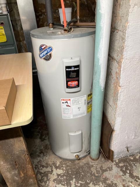 utility room featuring electric water heater