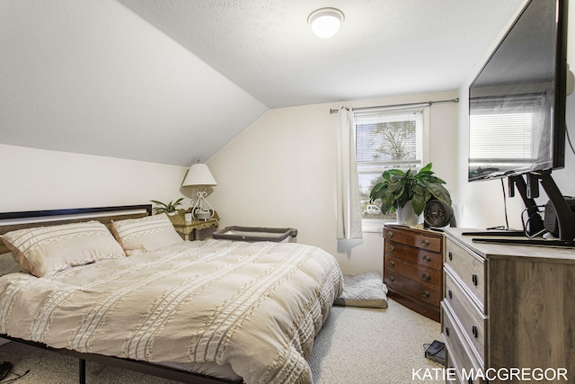 carpeted bedroom featuring a textured ceiling and vaulted ceiling