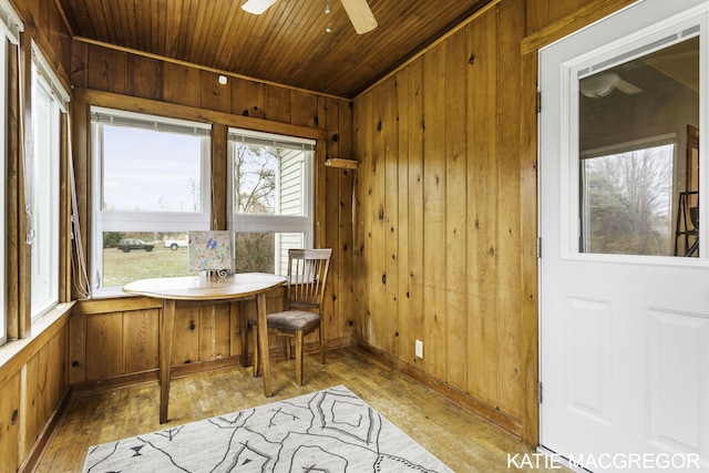 sunroom featuring ceiling fan and wood ceiling