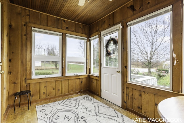 sunroom with plenty of natural light and wood ceiling