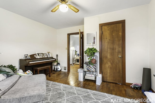 bedroom with ceiling fan and dark wood-type flooring