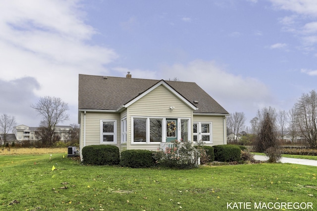 exterior space featuring a front yard and central AC