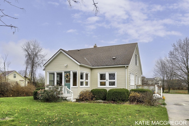 rear view of property with a yard