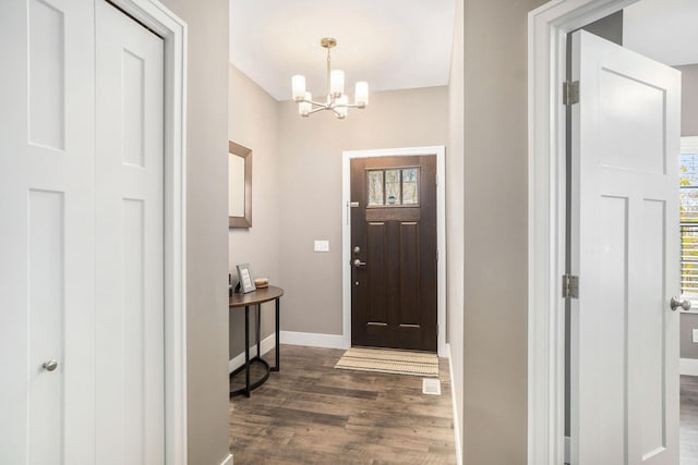 18481 N Fruitport Rd, Spring Lake, MI 49456 - entrance foyer with dark wood-style floors, a chandelier, baseboards, and healthy amount of natural light
