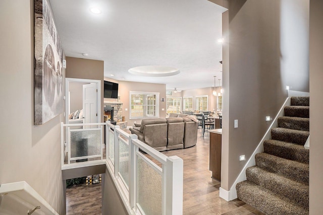 18481 N Fruitport Rd, Spring Lake, MI 49456 - stairway with wood finished floors, a fireplace, baseboards, and recessed lighting