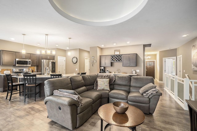 18481 N Fruitport Rd, Spring Lake, MI 49456 - living room featuring recessed lighting, light wood-style flooring, and bar