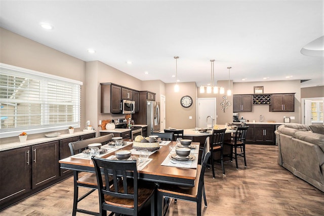 18481 N Fruitport Rd, Spring Lake, MI 49456 - dining area with wood finished floors, recessed lighting, and bar area