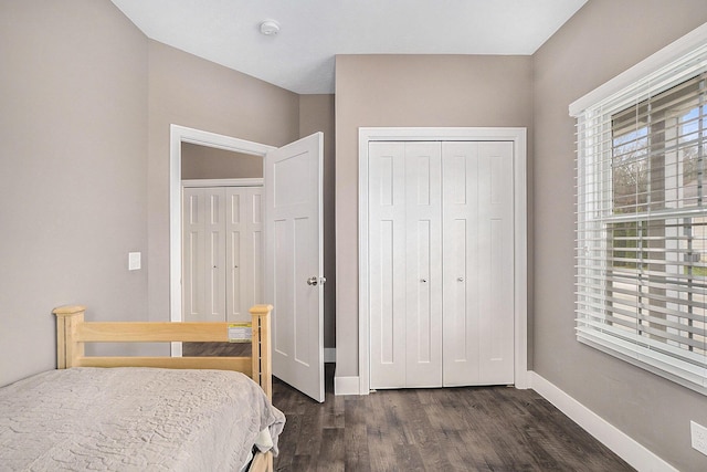 18481 N Fruitport Rd, Spring Lake, MI 49456 - bedroom with a closet, dark wood-style flooring, and baseboards
