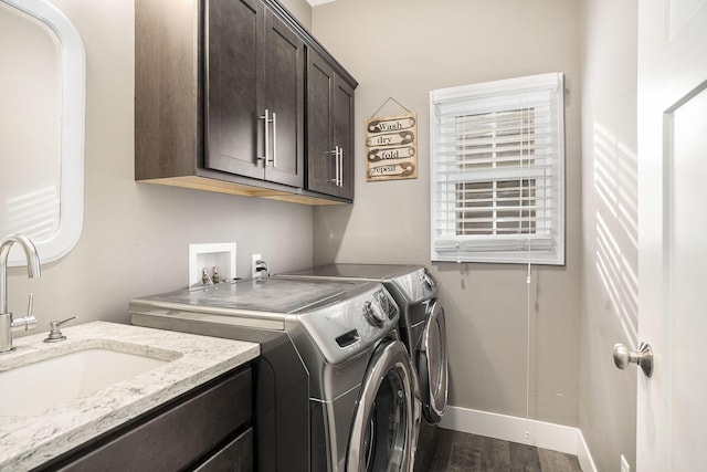 18481 N Fruitport Rd, Spring Lake, MI 49456 - washroom featuring cabinet space, separate washer and dryer, dark wood finished floors, and baseboards