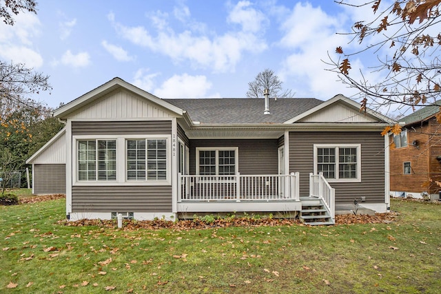 18481 N Fruitport Rd, Spring Lake, MI 49456 - rear view of house with a lawn, covered porch, and roof with shingles