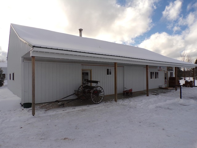 view of snow covered rear of property