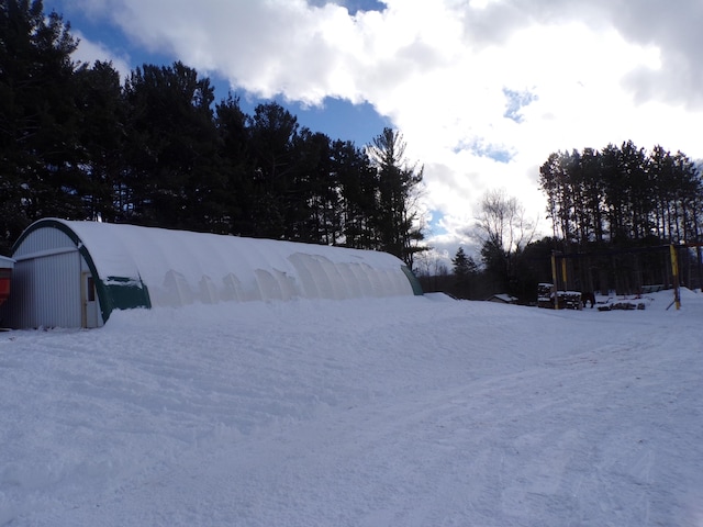 yard covered in snow with an outdoor structure