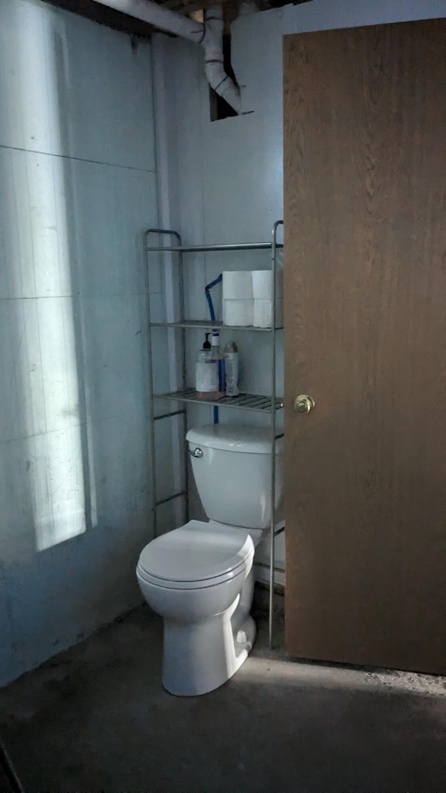 bathroom featuring toilet and concrete floors