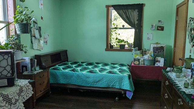 bedroom with dark hardwood / wood-style flooring