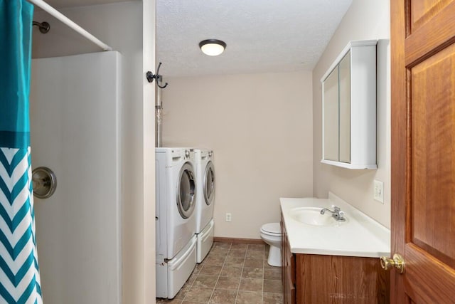 washroom featuring sink, a textured ceiling, and independent washer and dryer