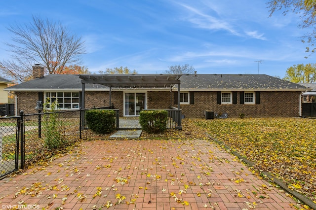 back of property with central AC unit and a pergola