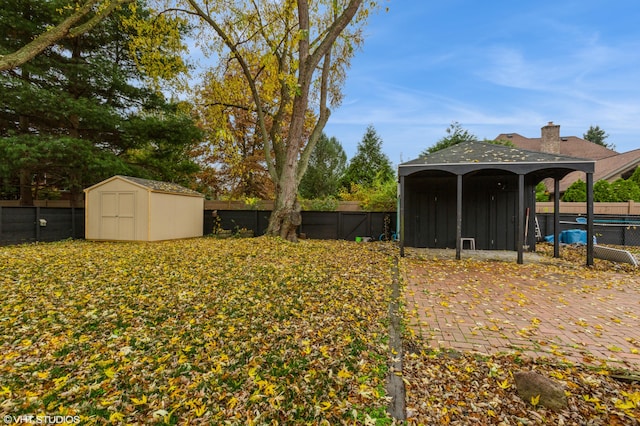 view of yard with a storage unit and a fenced in pool