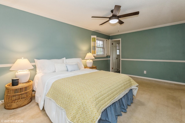 carpeted bedroom featuring ceiling fan and ornamental molding