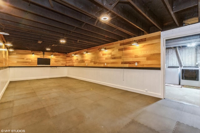 basement with independent washer and dryer and wooden walls