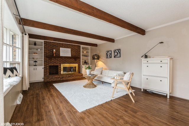 living room featuring beam ceiling, dark wood-type flooring, and a brick fireplace