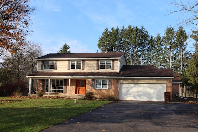 view of property featuring a front yard and a garage