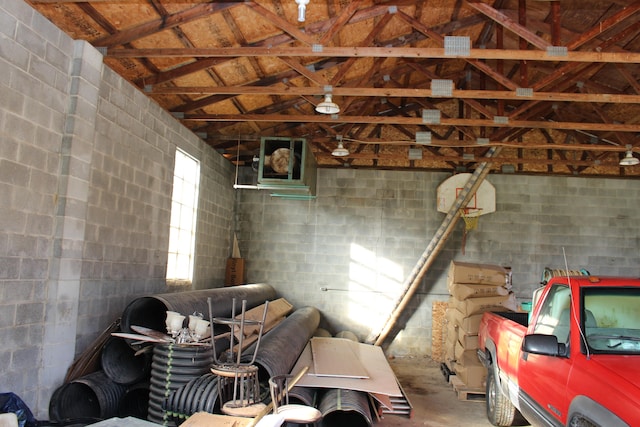 interior space featuring lofted ceiling and concrete floors